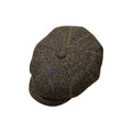 A classic newsboy cap in a brown and black houndstooth pattern with subtle blue and beige flecks, photographed on a solid white background.