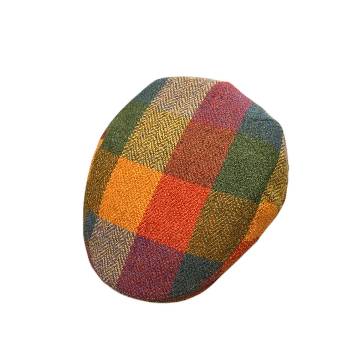 A small oval-shaped patch of multicolor plaid fabric, featuring orange, green, red, and brown tones, isolated on a solid white background.